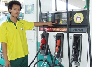 Pathawee Duakhanad, a Petronas pump employee, shows how cheap petrol has become.